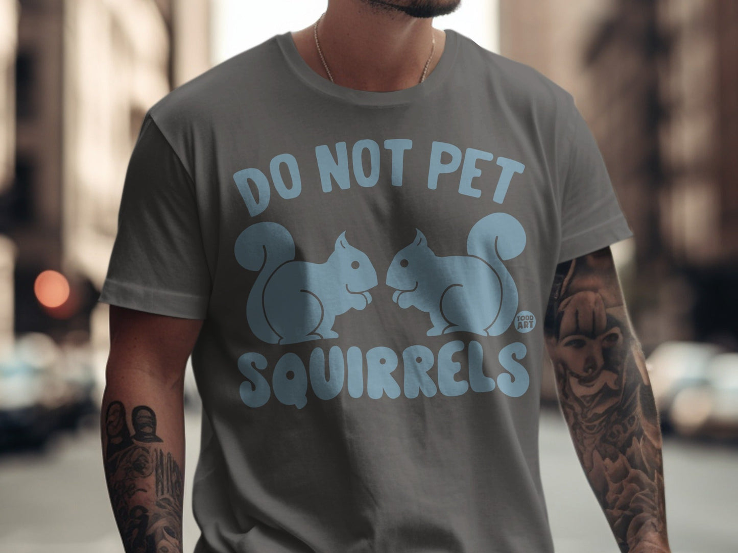 Gray t-shirt with light blue text "DO NOT PET SQUIRRELS" and two cartoon squirrels.