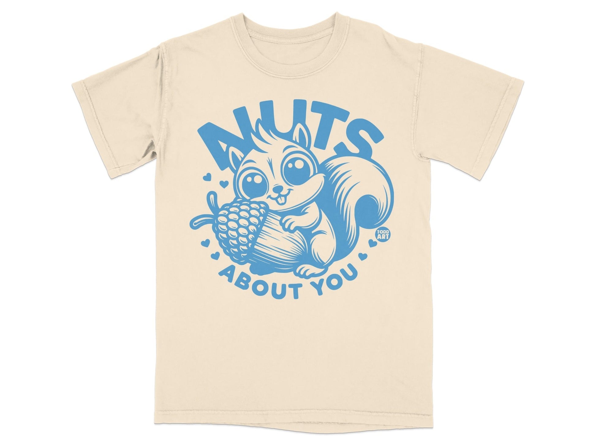 Cream t-shirt with blue cartoon squirrel holding acorn, "NUTS ABOUT YOU" text.