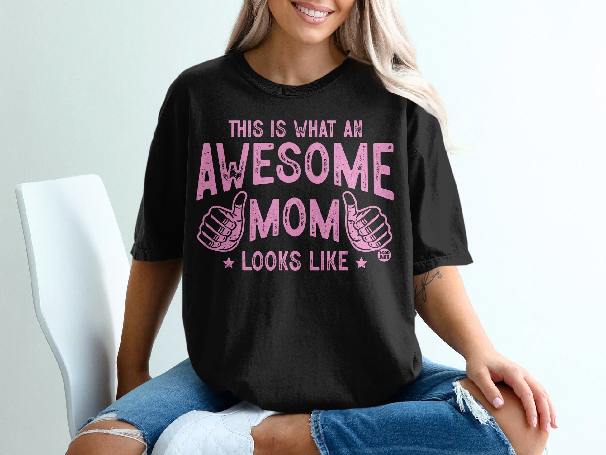 Black t-shirt with "This is what an awesome mom looks like" in pink text.