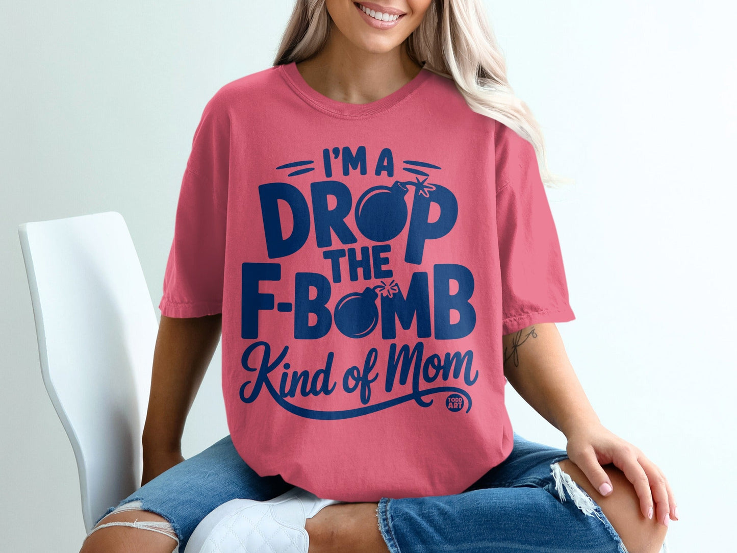 Pink t-shirt with "I'm a drop the F-bomb kind of mom" text and bomb graphic.