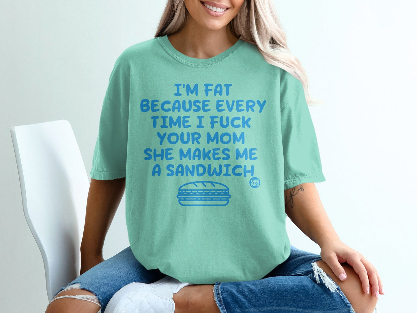 Teal t-shirt with "I'm fat because every time I fuck your mom she makes me a sandwich" text.