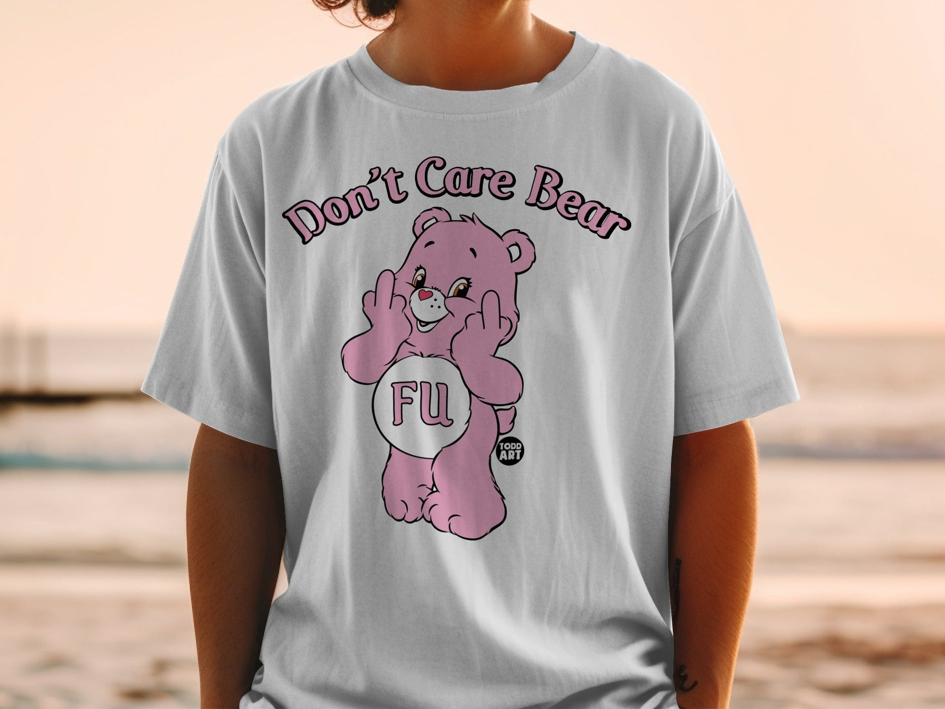 Pink Care Bear graphic tee with "FU" and middle fingers displayed.