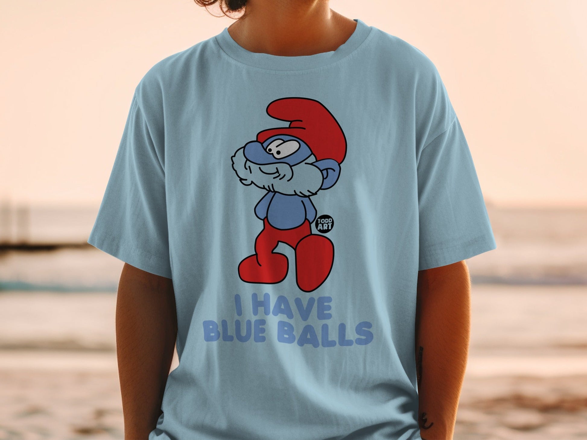 Light blue t-shirt with cartoon Smurf saying "I HAVE BLUE BALLS".