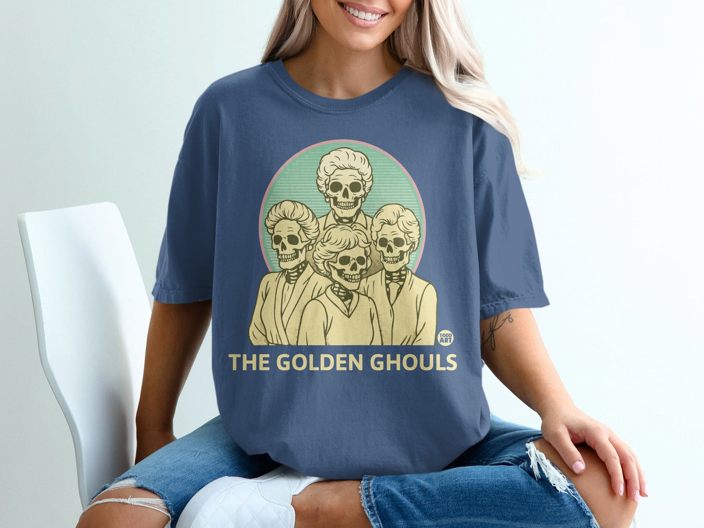 Navy t-shirt with "The Golden Ghouls" text and a retro illustration of skulls.