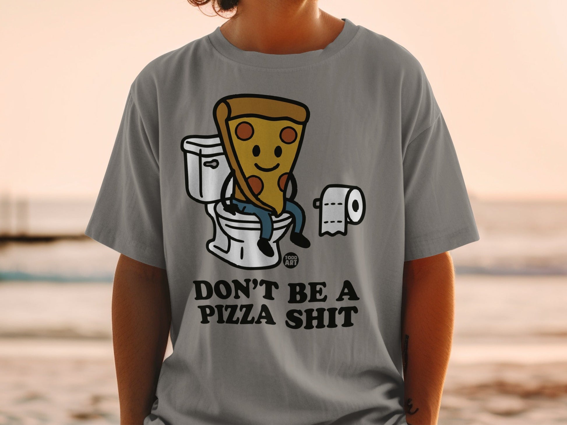 T-shirt with cartoon pizza slice on toilet, text "DON'T BE A PIZZA SHIT".