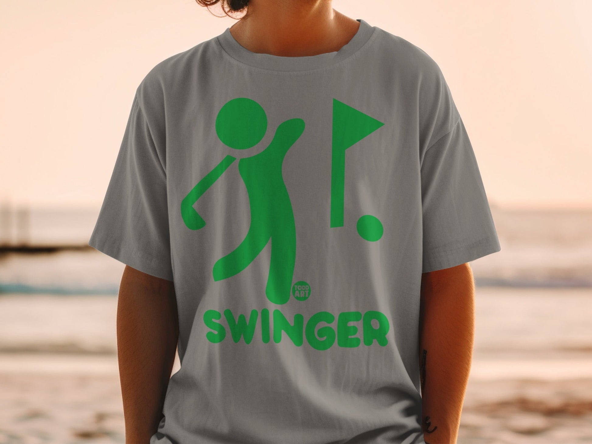 Gray t-shirt with green golf graphic and "SWINGER" text.