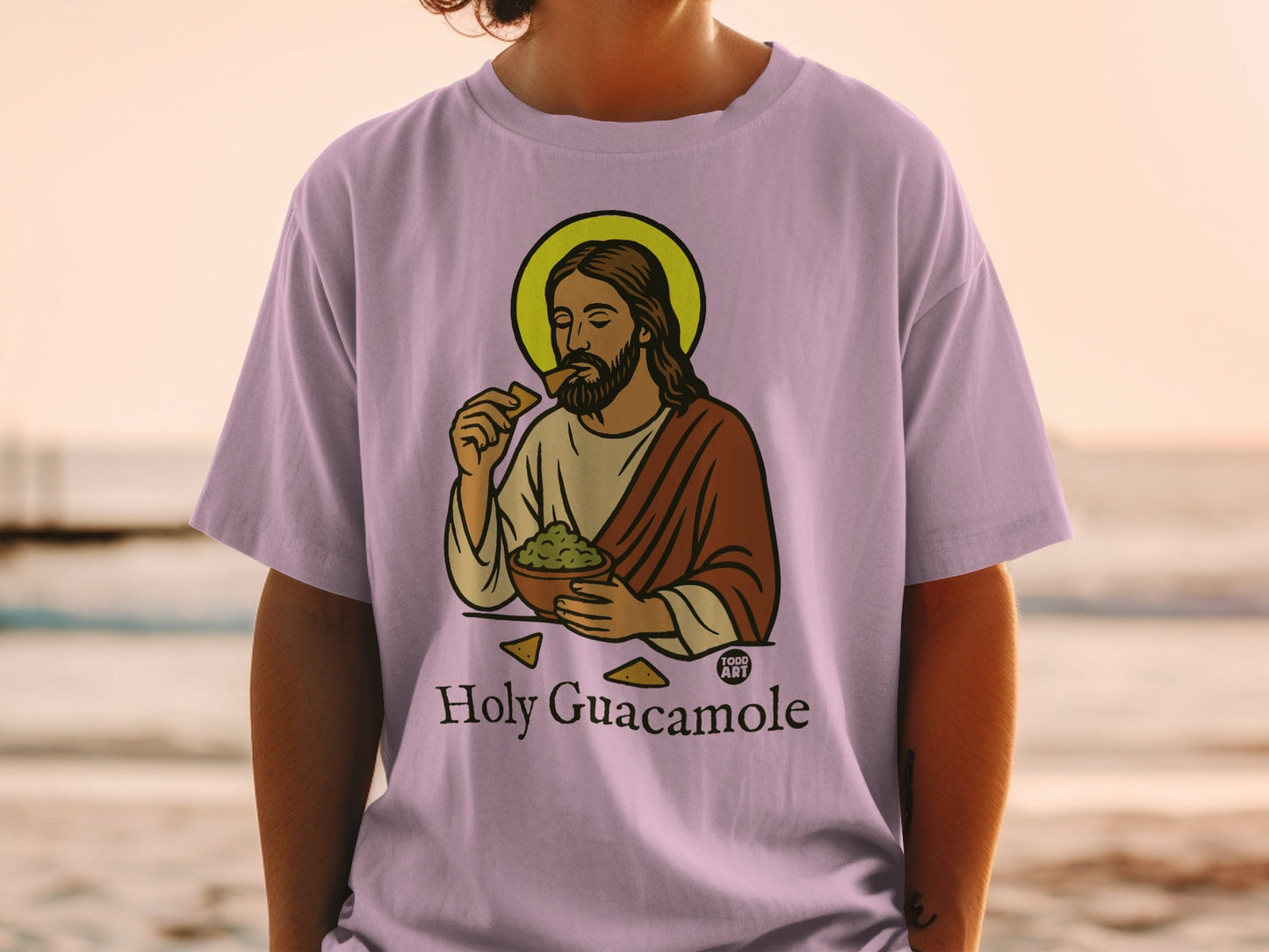 Jesus Christ wearing a halo eats guacamole and chips on a t-shirt.