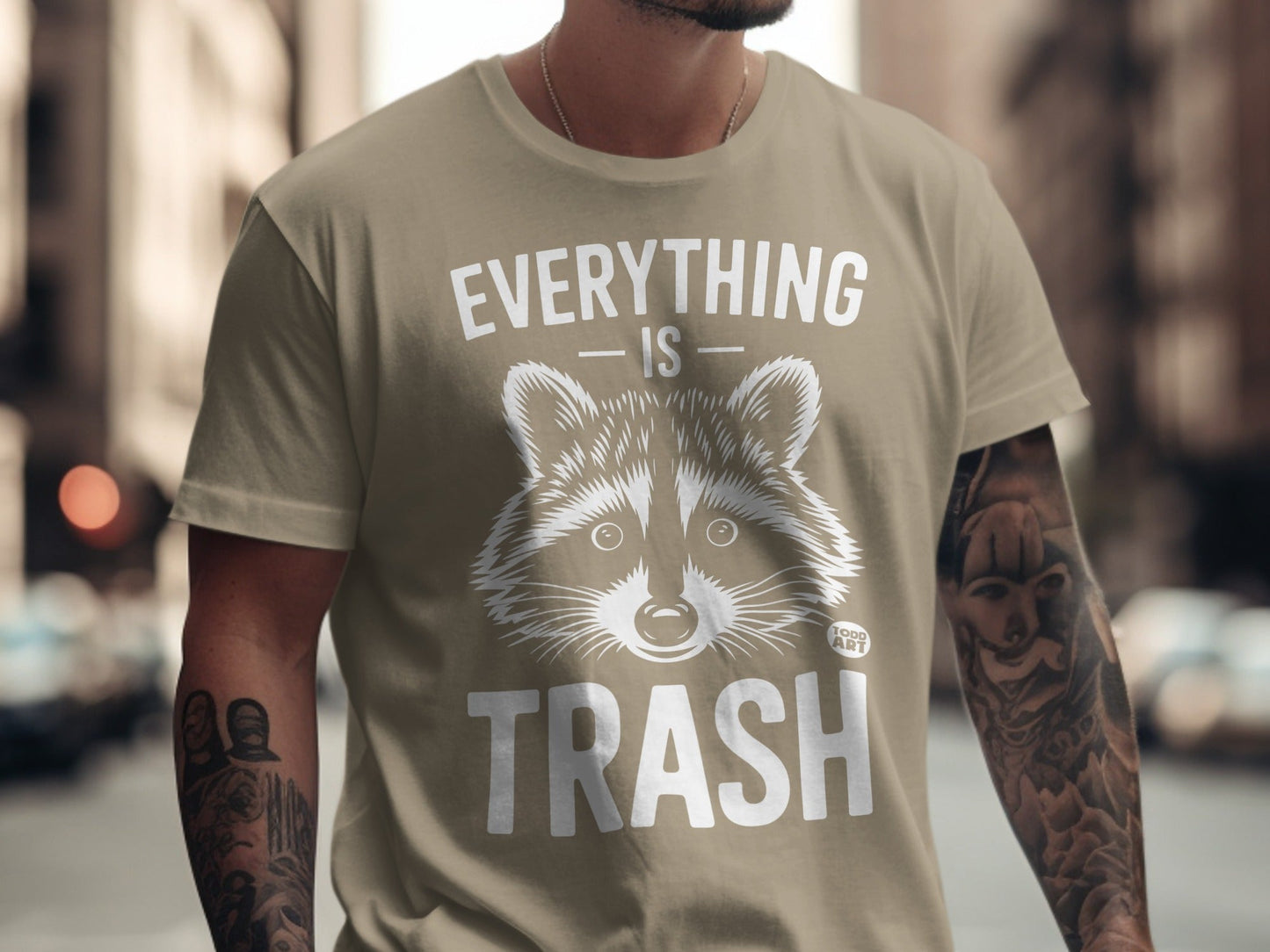Tan t-shirt with raccoon graphic and text "EVERYTHING IS TRASH"