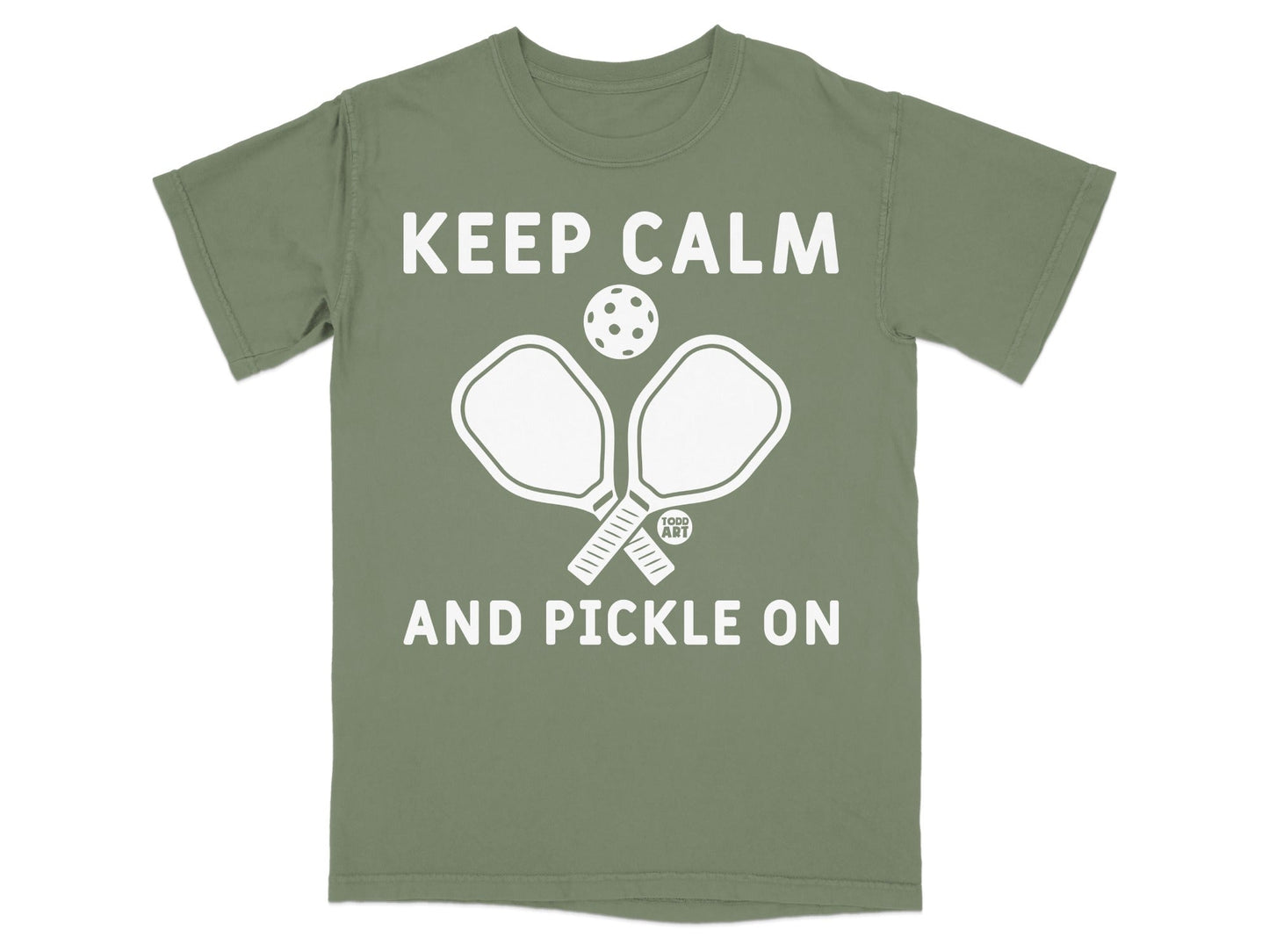T-shirt with "Keep Calm and Pickle On" and pickleball paddles and ball.