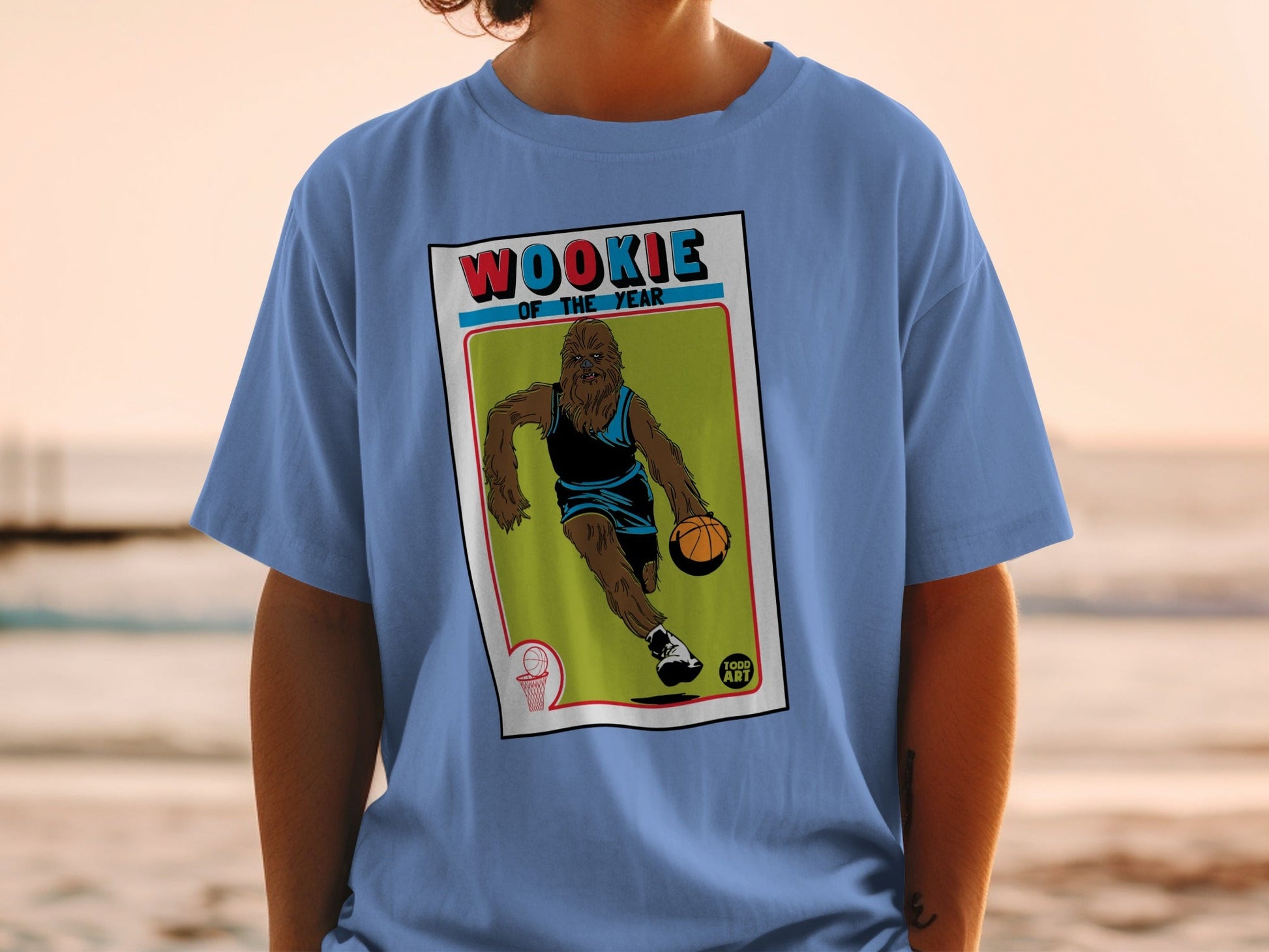 Blue t-shirt featuring a Wookiee playing basketball on a vintage trading card.