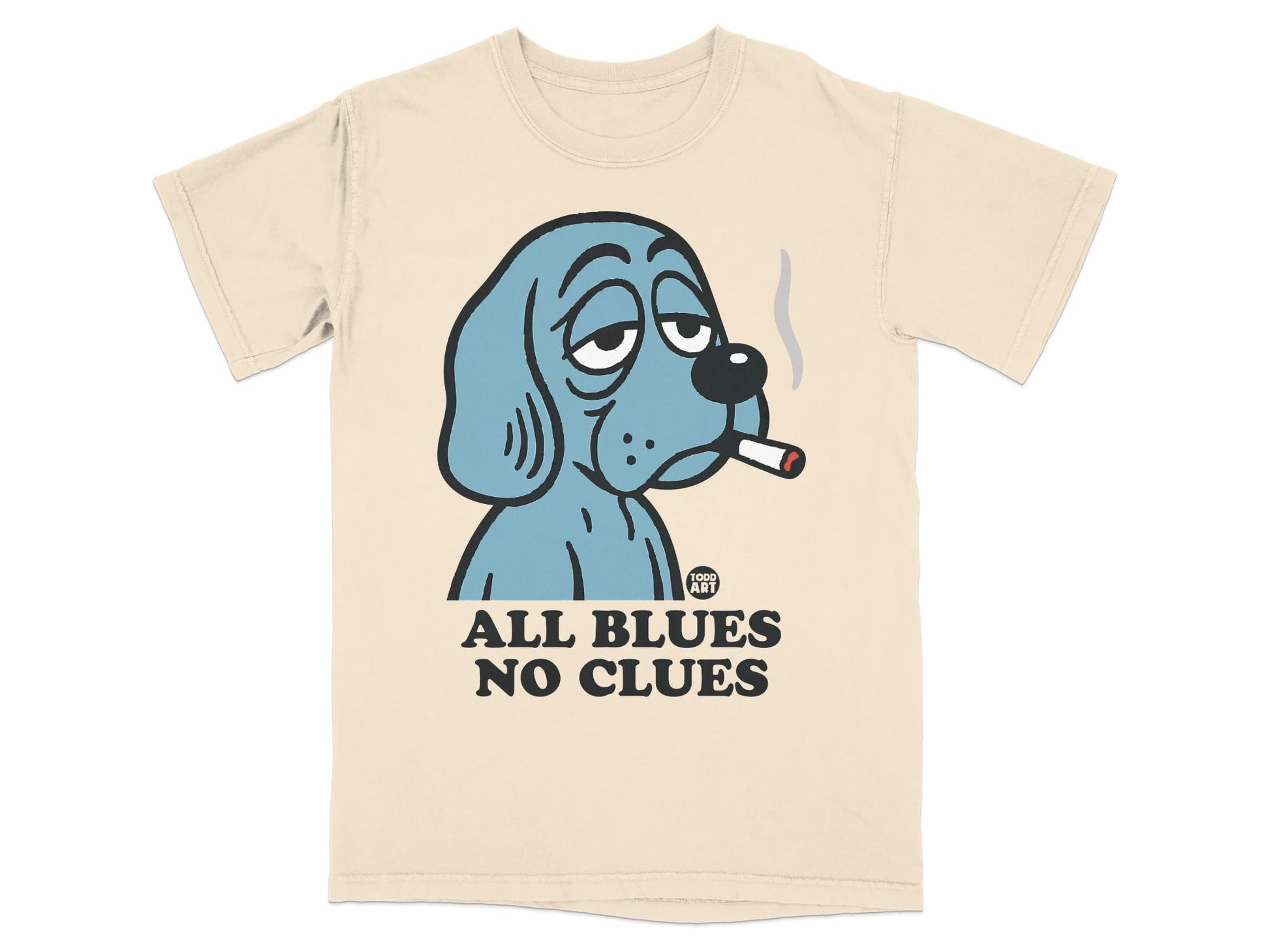 Blue dog with cigarette, "ALL BLUES NO CLUES" text on cream t-shirt.