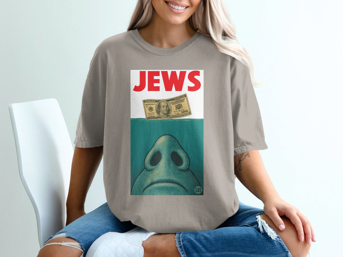 T-shirt with "JEWS" text above underwater shark face and dollar bill.