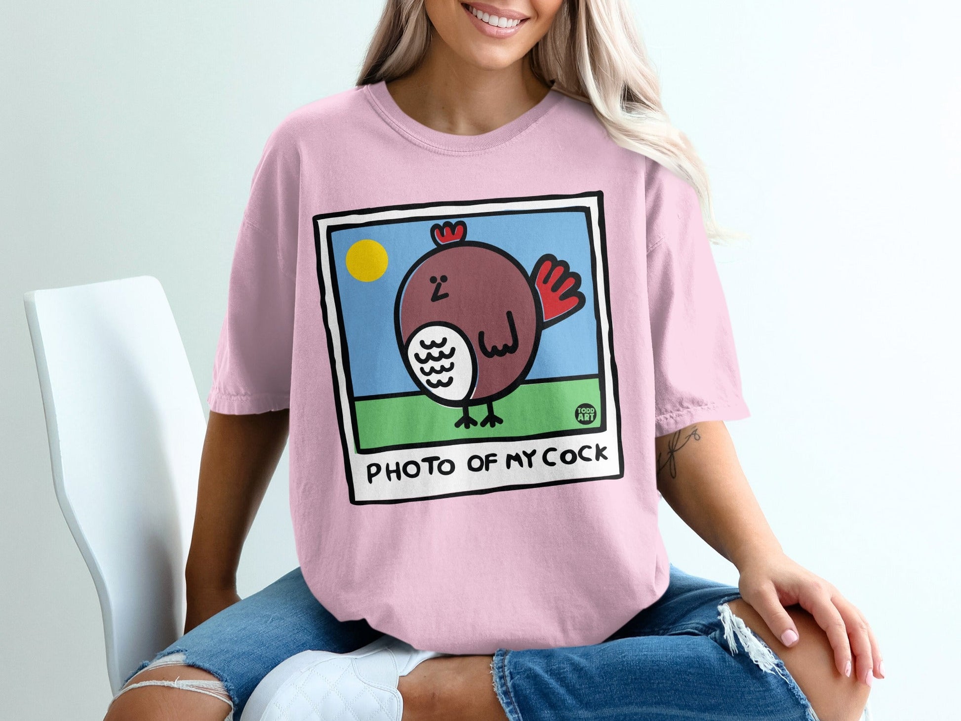Pink t-shirt with cartoon chicken graphic and text "PHOTO OF MY COCK".