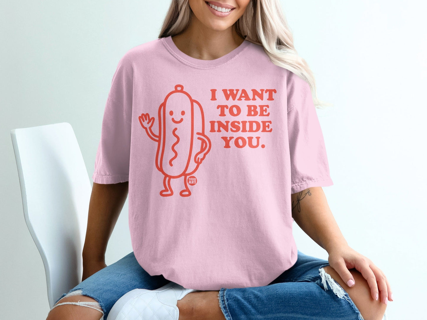 Pink t-shirt with a hot dog graphic and text "I WANT TO BE INSIDE YOU."