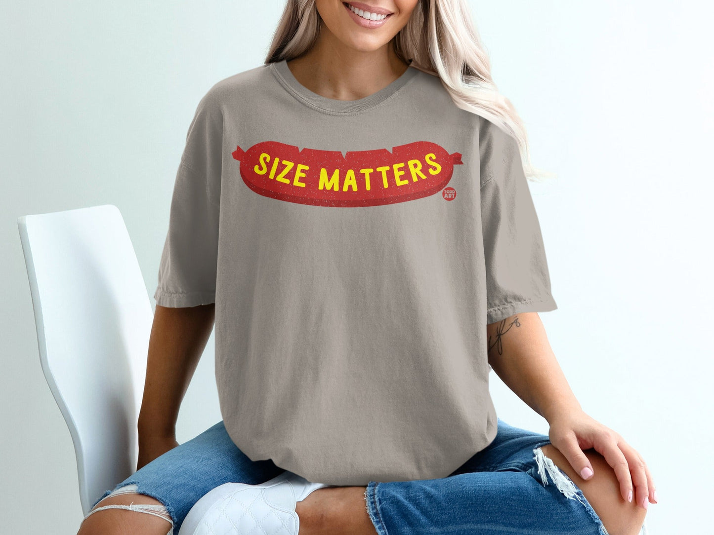 Brown t-shirt with red sausage graphic and "Size Matters" text.
