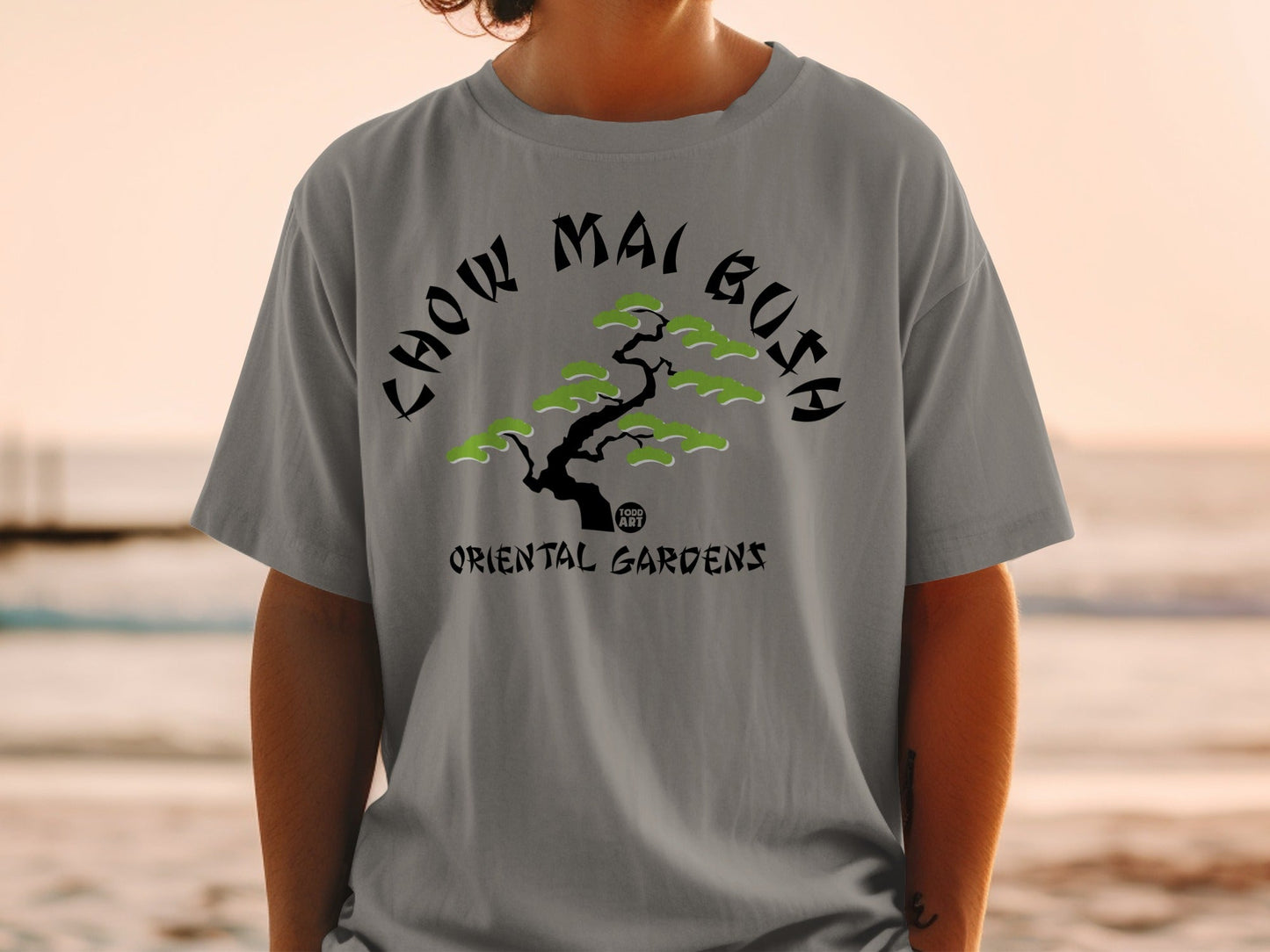 Grey t-shirt with "Chow Mai Gusa Oriental Gardens" text and stylized tree.