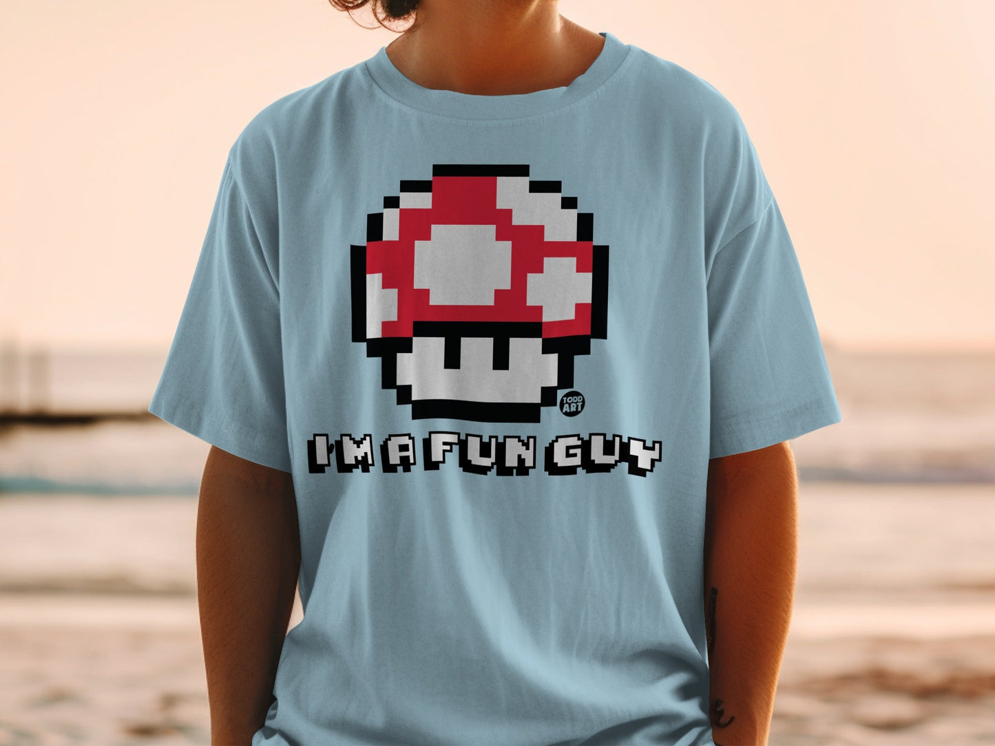 Light blue t-shirt with 8-bit mushroom and "IMA FUN GUY" text.