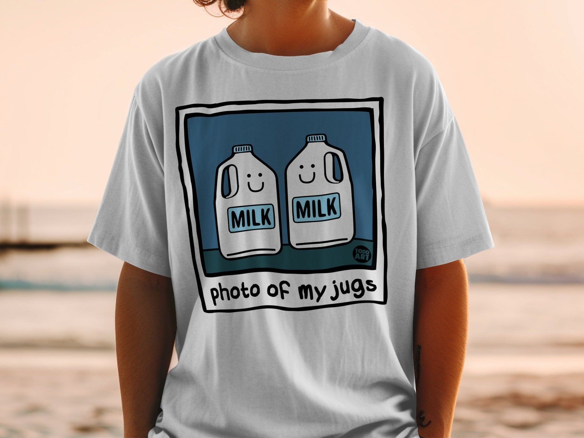 T-shirt with cartoon milk jugs and "photo of my jugs" text.
