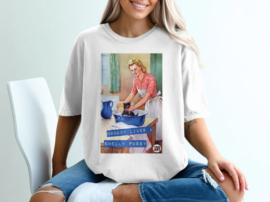 Woman washes a cat in a sink with text "NOBODY LIKES A SMELLY PUSSY".