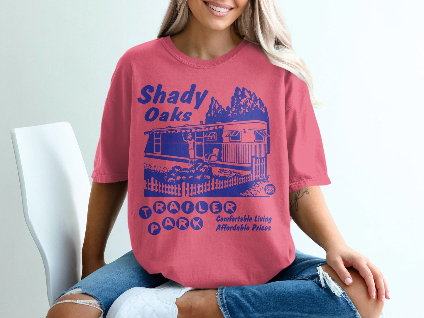 Shady Oaks Trailer Park graphic tee with trailer, trees, and fence.