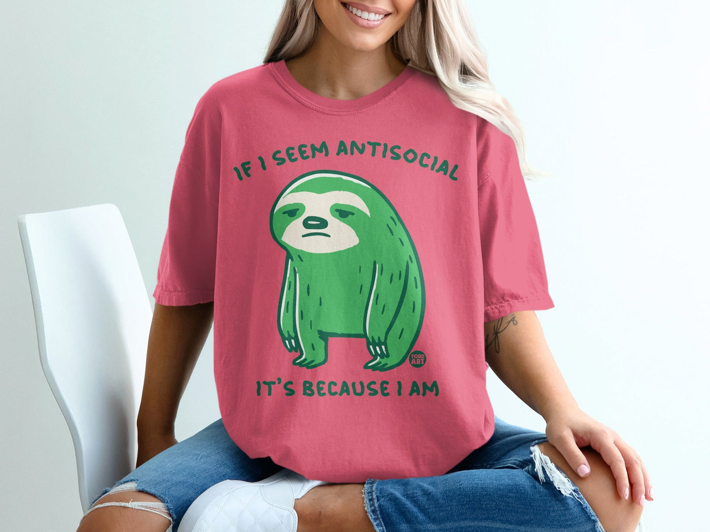 Pink t-shirt with green sloth graphic and text "IF I SEEM ANTISOCIAL IT'S BECAUSE I AM".