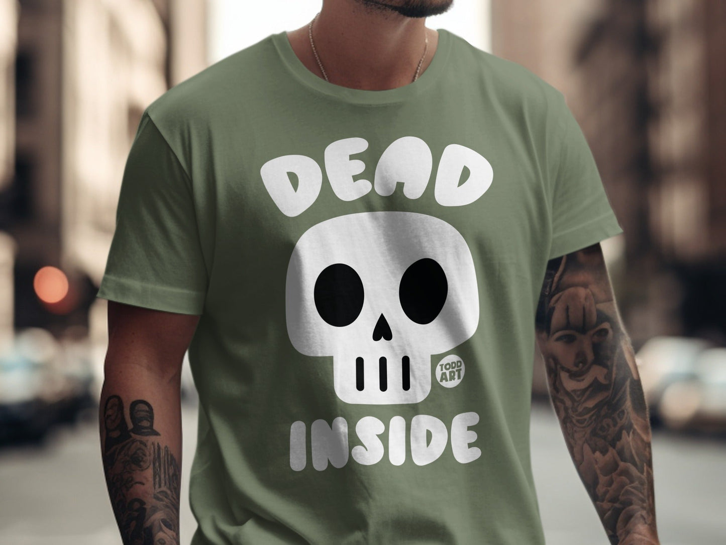 Olive green t-shirt with "DEAD INSIDE" text and a skull graphic.