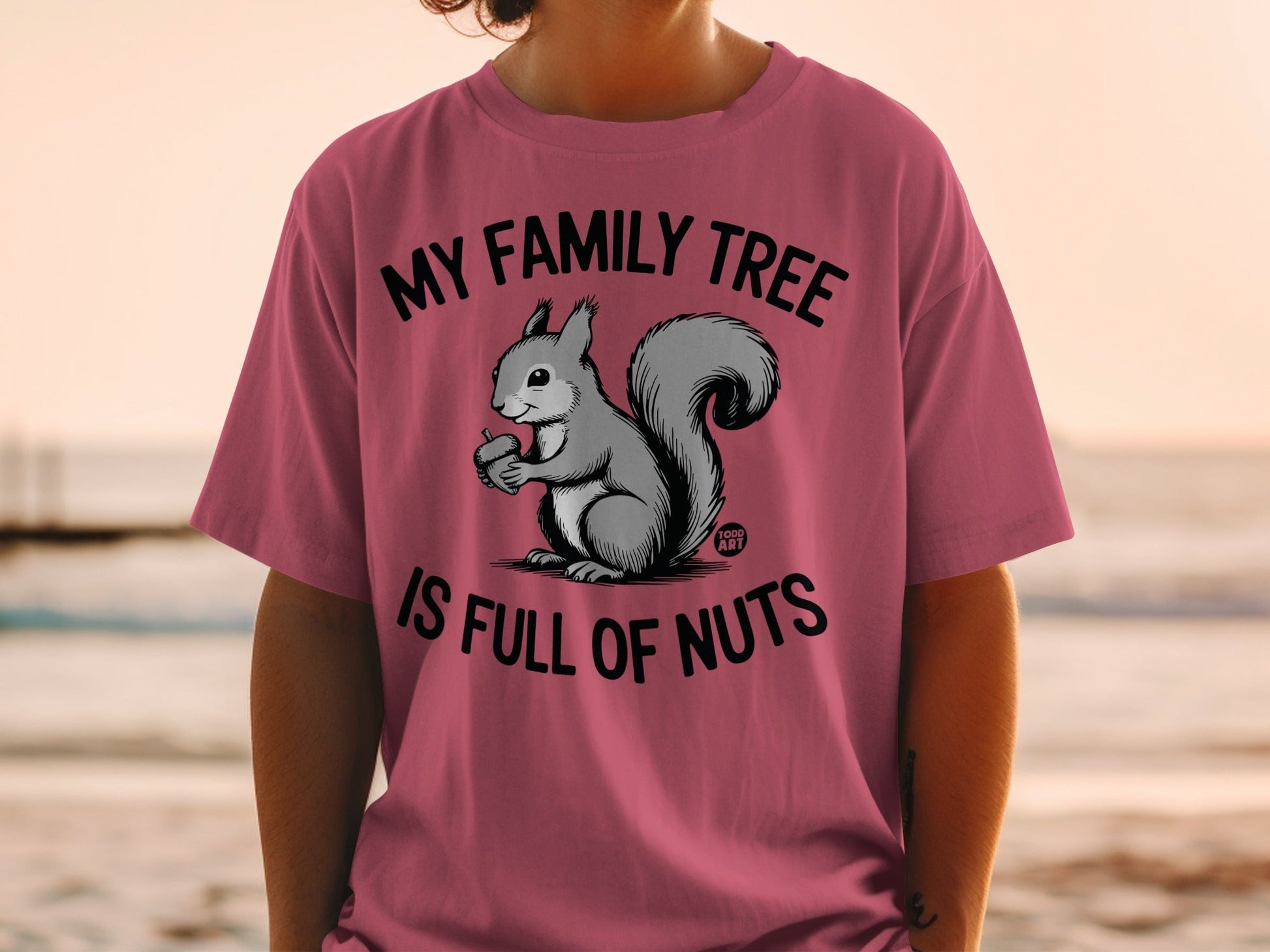 T-shirt with a squirrel holding an acorn and text "My family tree is full of nuts".