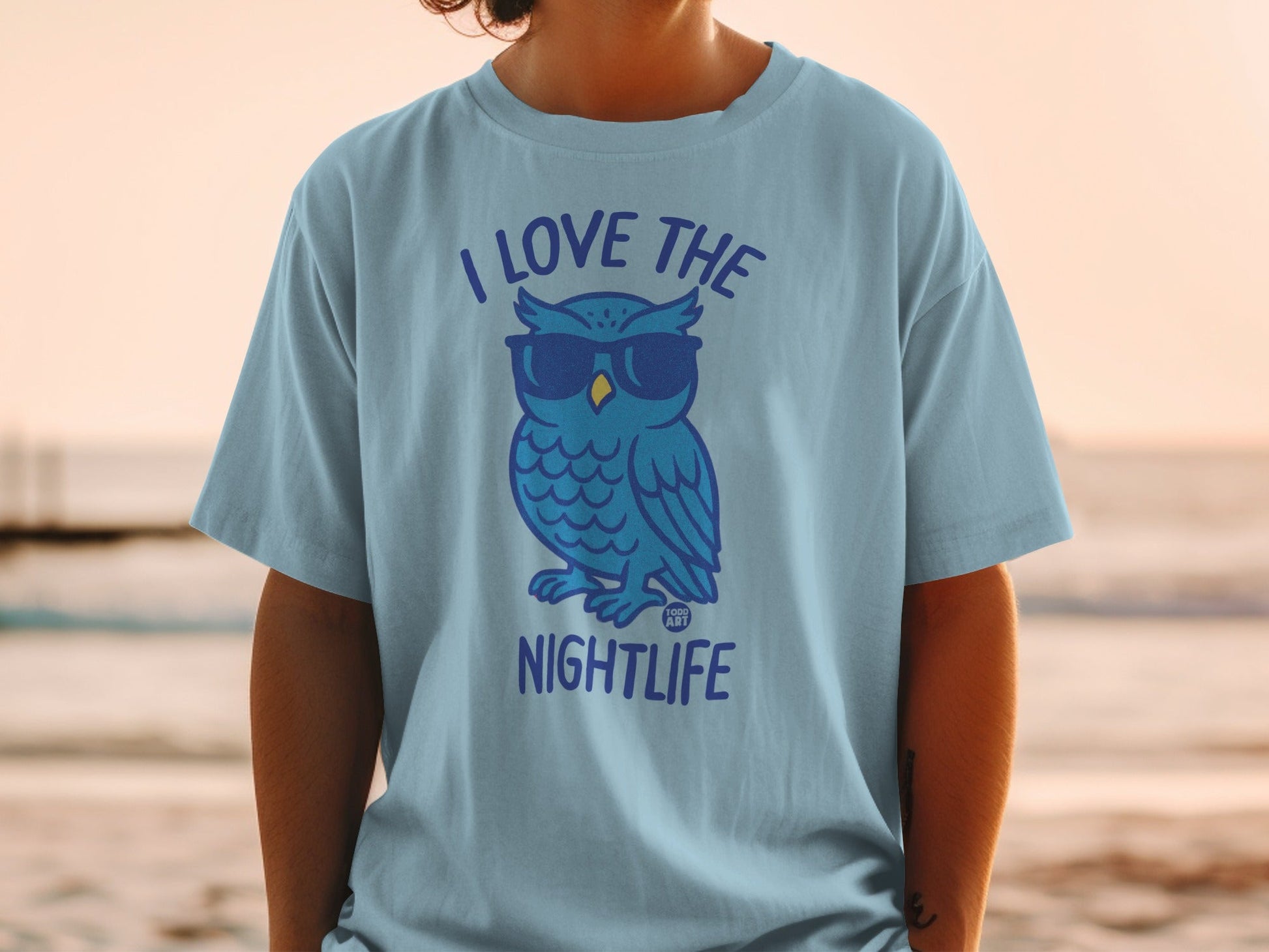 Light blue t-shirt with a cartoon owl wearing sunglasses, text "I LOVE THE NIGHTLIFE".