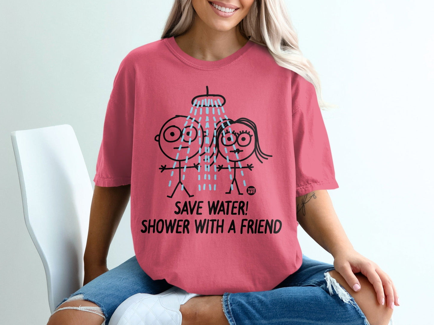 Pink t-shirt with cartoon shower graphic and "SAVE WATER! SHOWER WITH A FRIEND!" text.