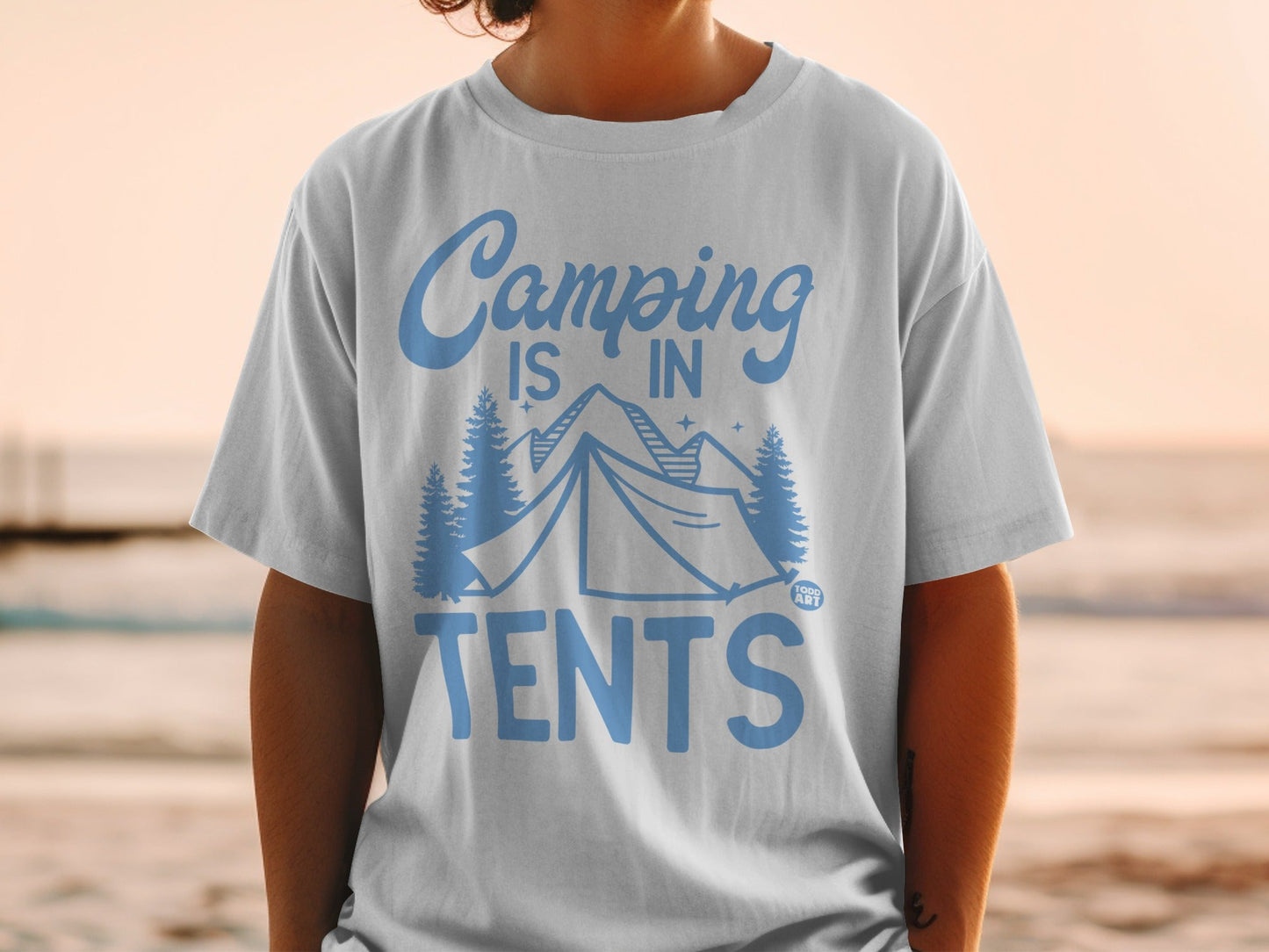 White t-shirt with blue text and trees, reads "Camping is in tents".