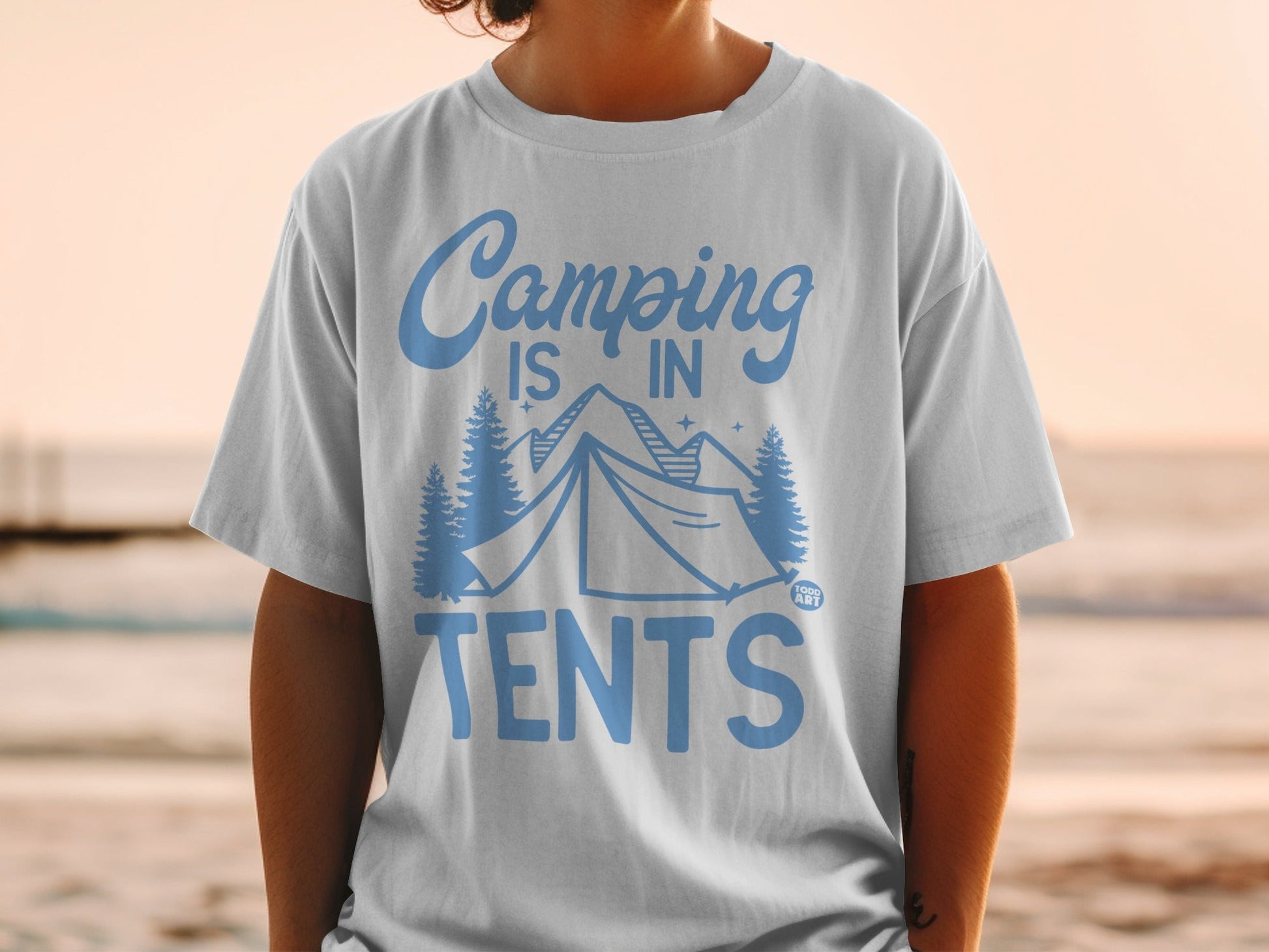 White t-shirt with blue text and trees, reads "Camping is in tents".