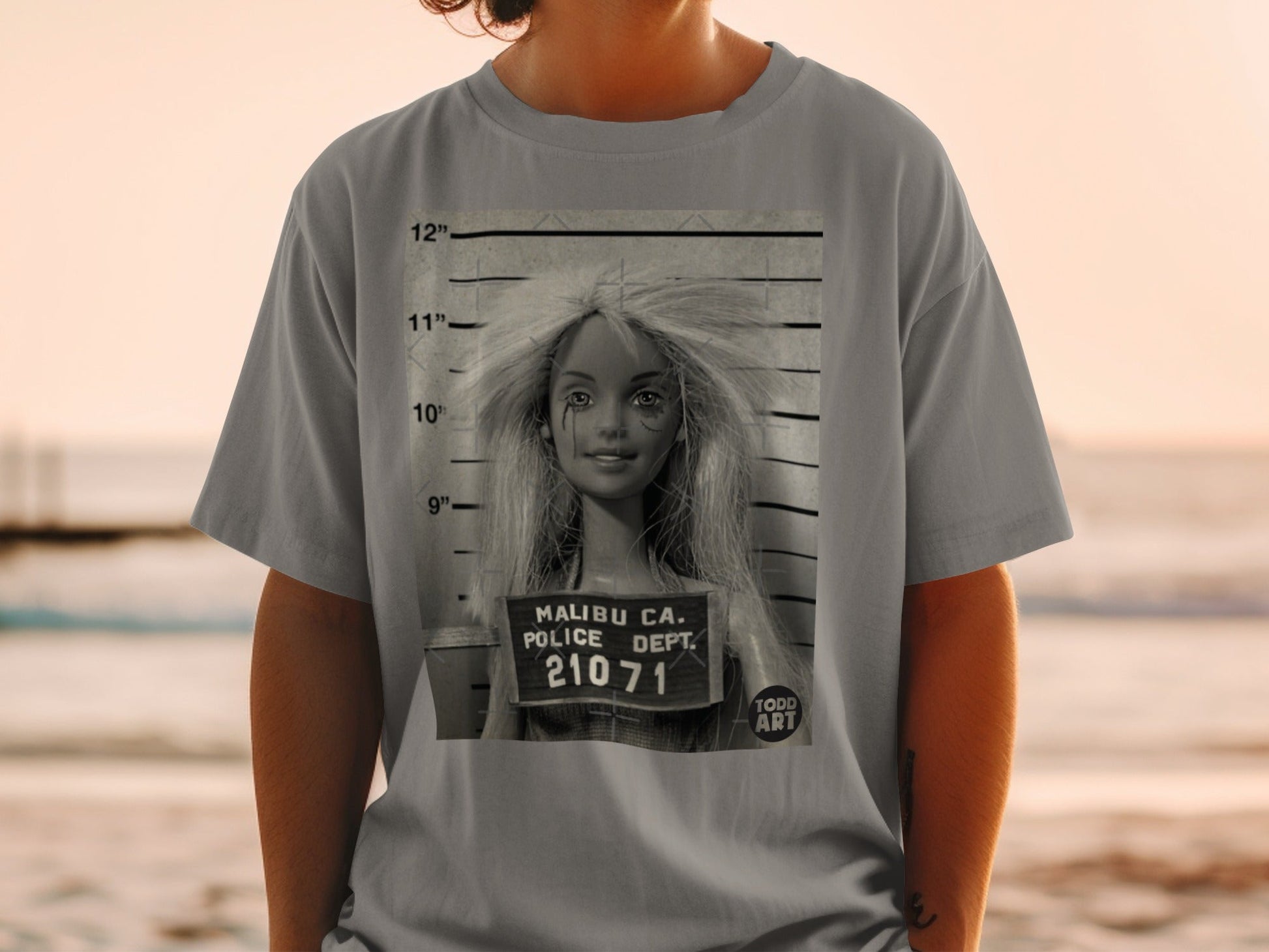 T-shirt with a mugshot of a blonde woman with "Malibu Ca. Police Dept. 21071" text.
