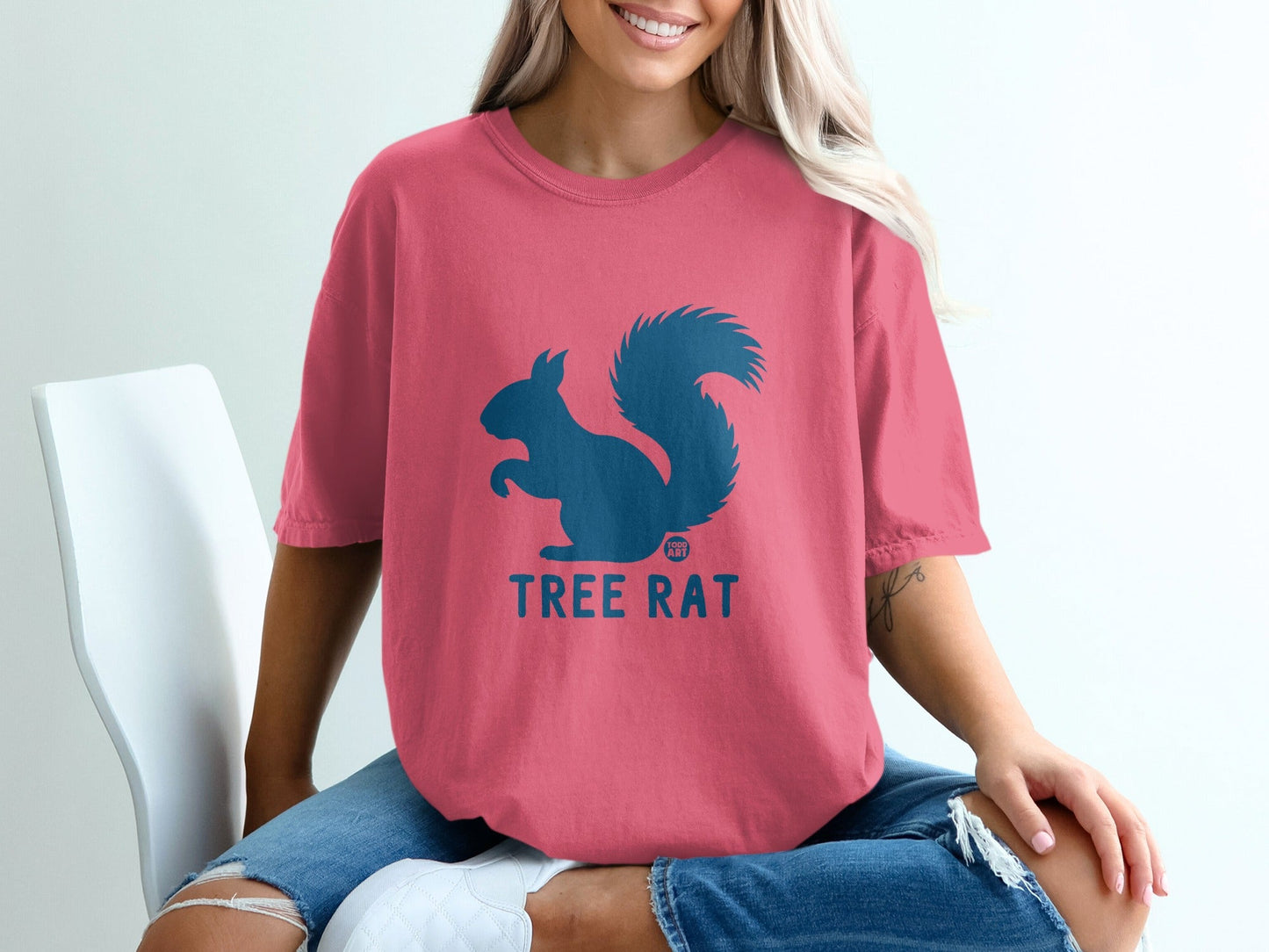 Pink t-shirt with a dark blue squirrel graphic and "TREE RAT" text.