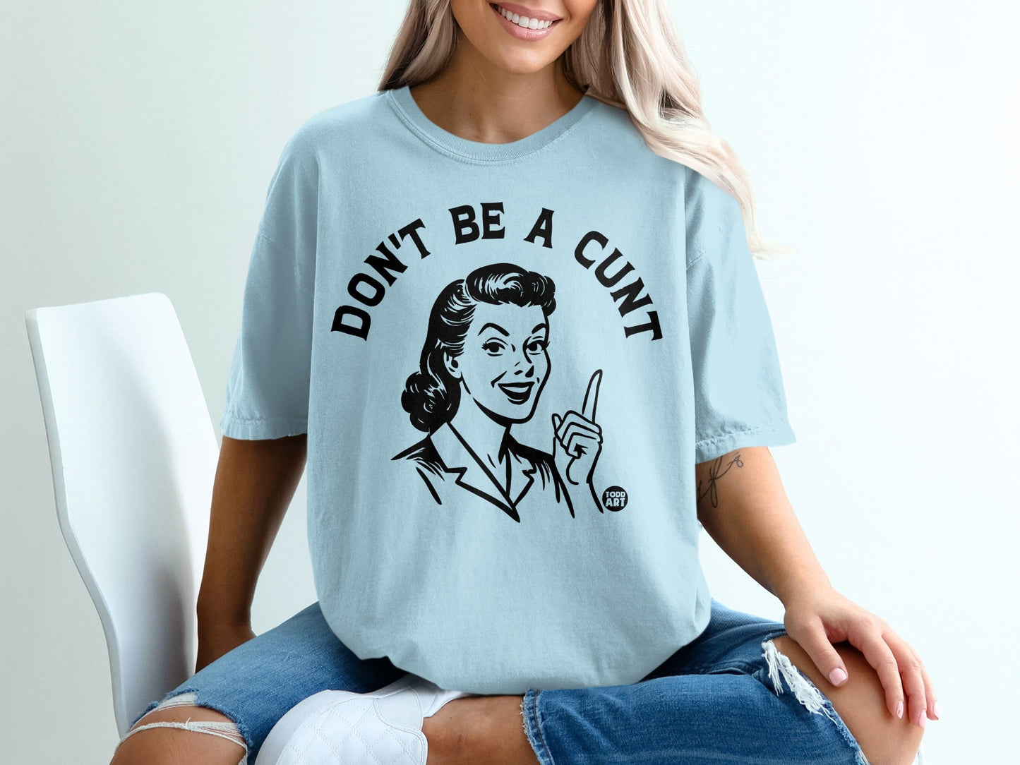Light blue t-shirt with black text and graphic, "Don't be a Cunt".