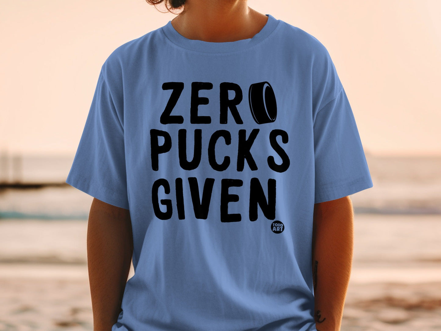 Blue t-shirt with "ZERO PUCKS GIVEN" text and a hockey puck.