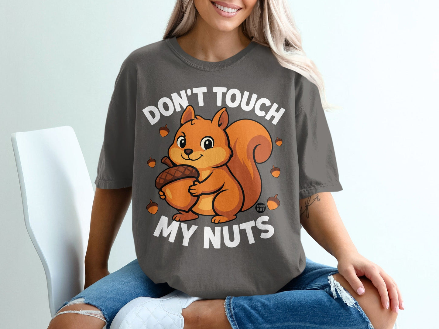 Dark gray t-shirt with cartoon squirrel holding an acorn, text reads "Don't touch my nuts".