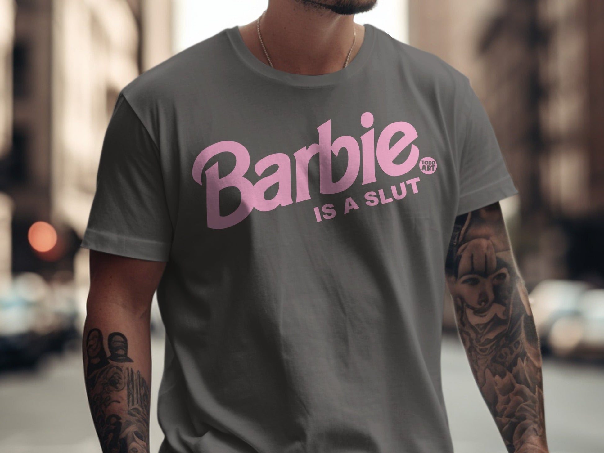 Gray t-shirt with "Barbie IS A SLUT" in pink lettering.