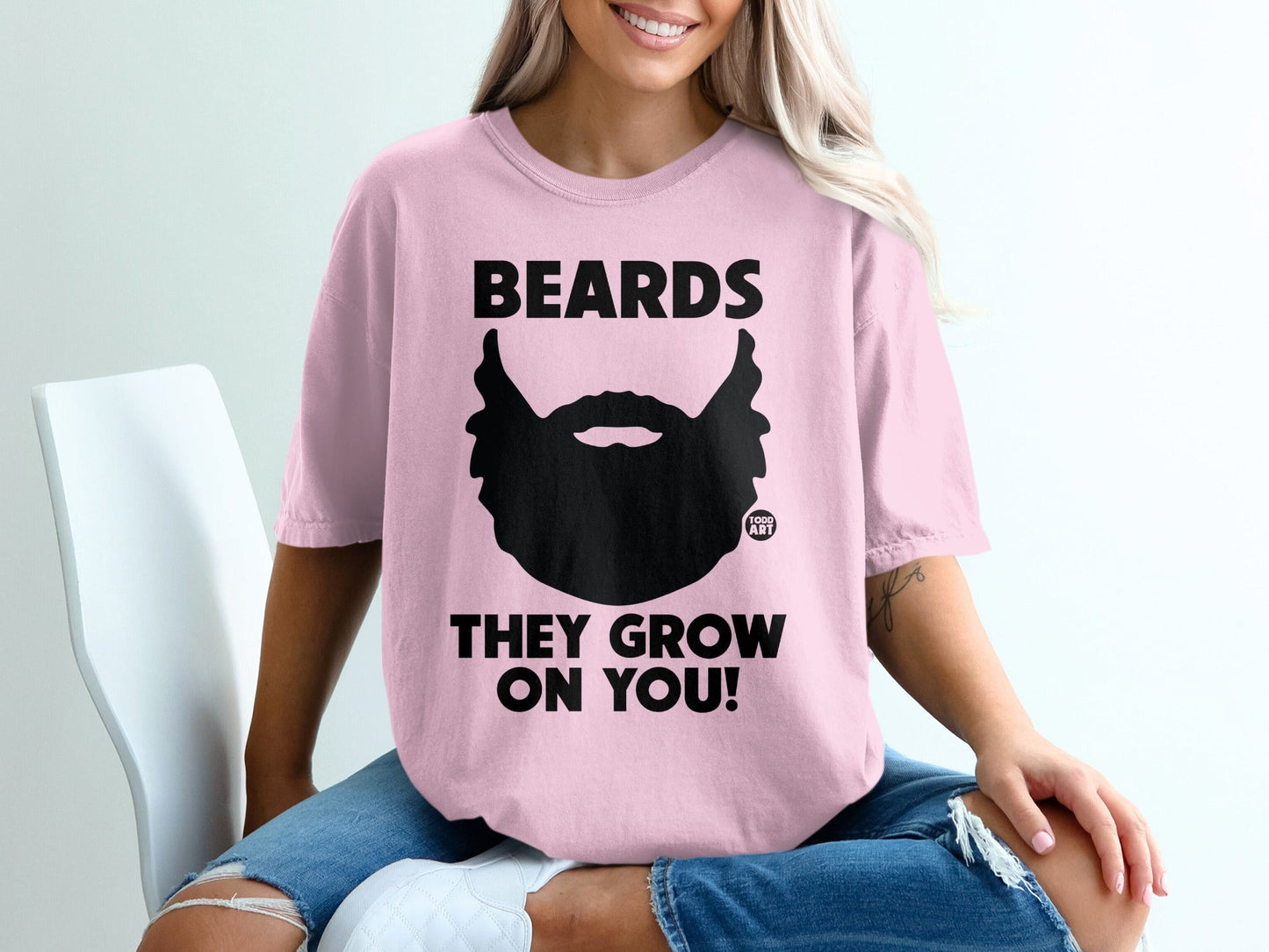 Pink t-shirt with black beard graphic and text "BEARDS THEY GROW ON YOU!".