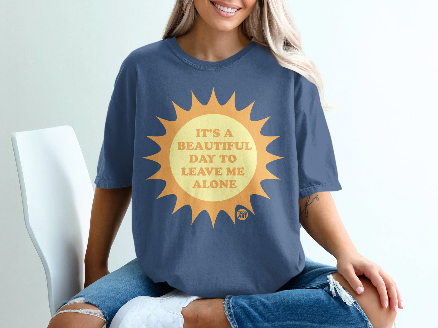 Blue t-shirt with sun graphic and text "It's a beautiful day to leave me alone".
