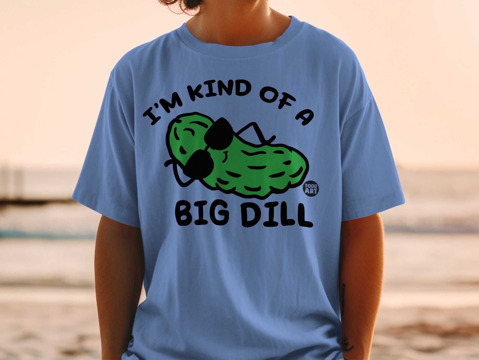 Light blue t-shirt with a cartoon pickle wearing sunglasses and text "I'M KIND OF A BIG DILL".