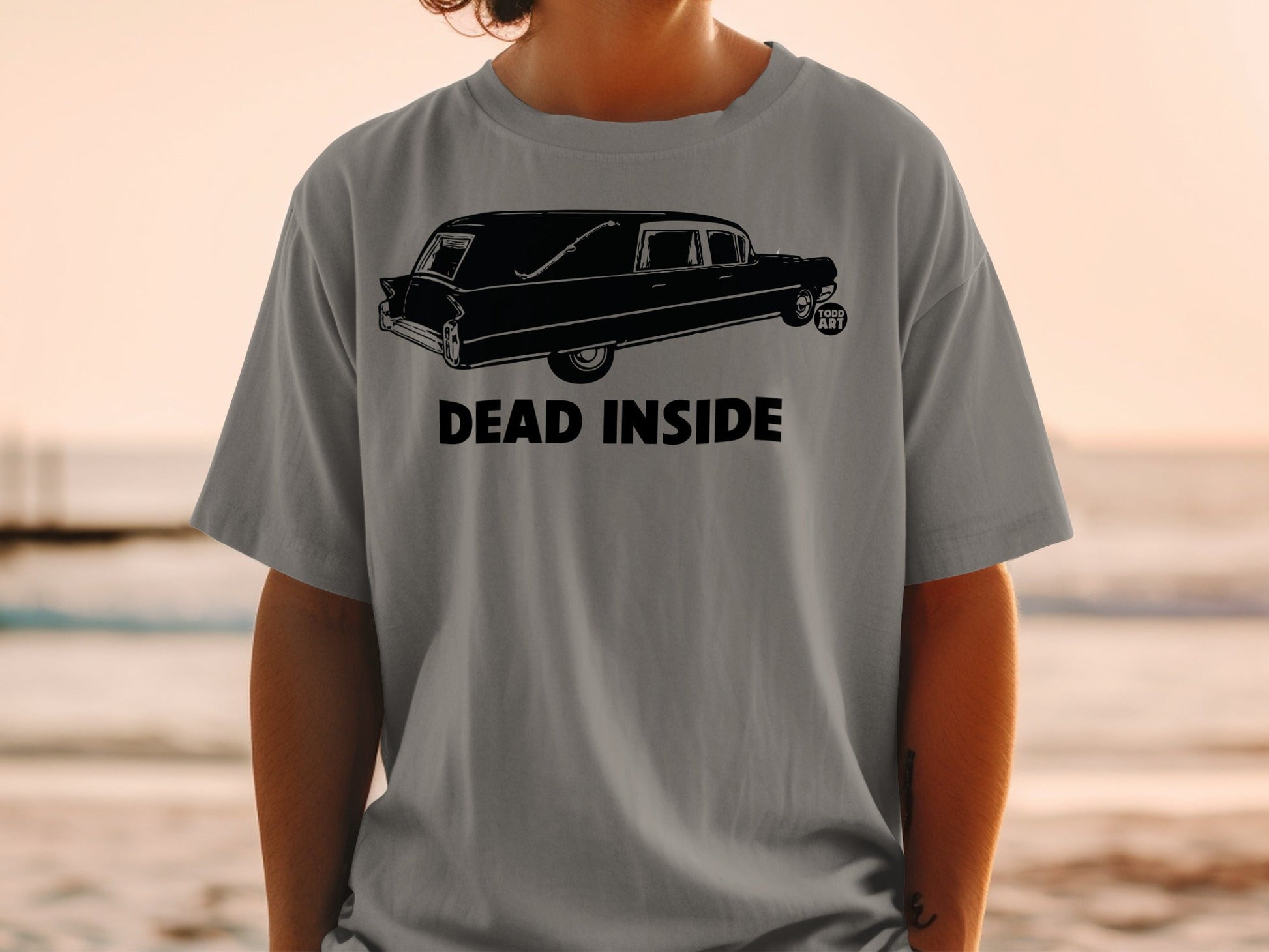 Gray t-shirt with a black hearse graphic and "DEAD INSIDE" text.