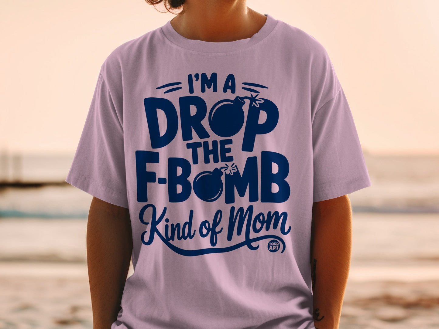 Purple t-shirt with "I'm a drop the f-bomb kind of mom" text and bomb graphic.