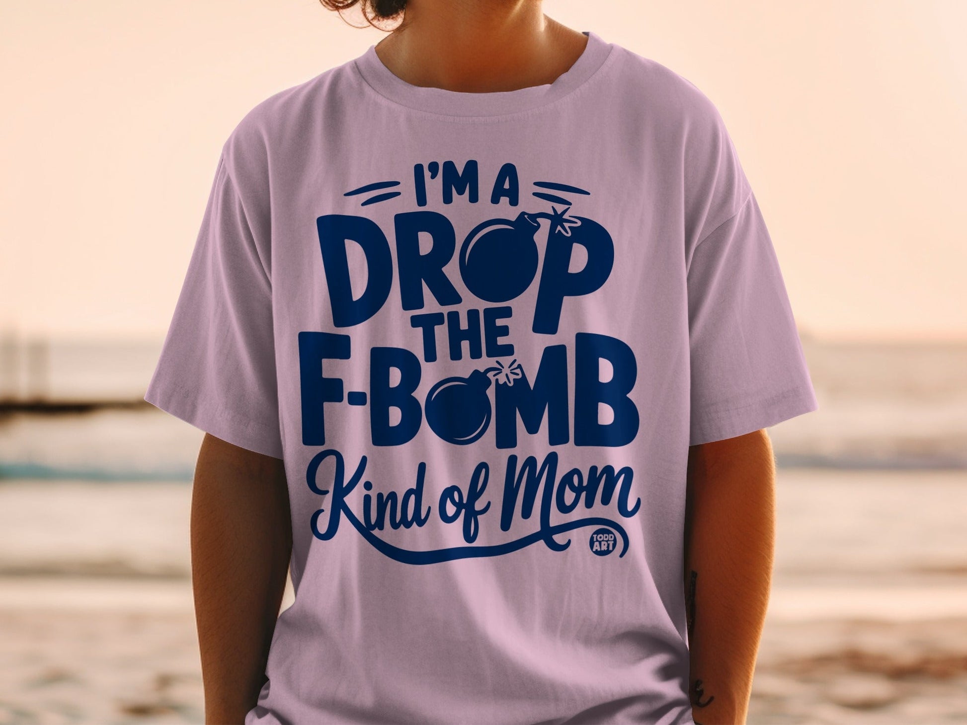 Purple t-shirt with "I'm a drop the f-bomb kind of mom" text and bomb graphic.