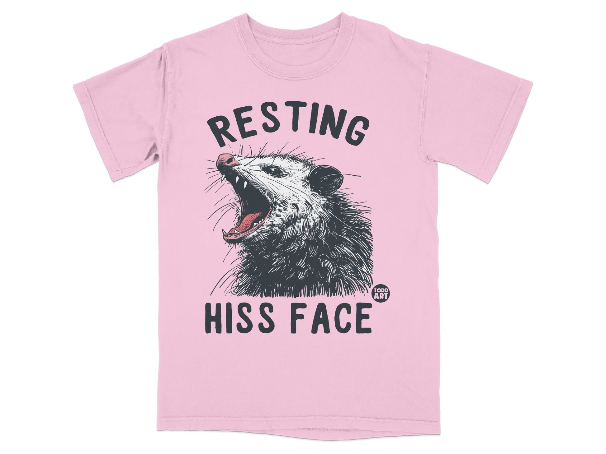 Pink t-shirt with possum graphic and text "RESTING HISS FACE".