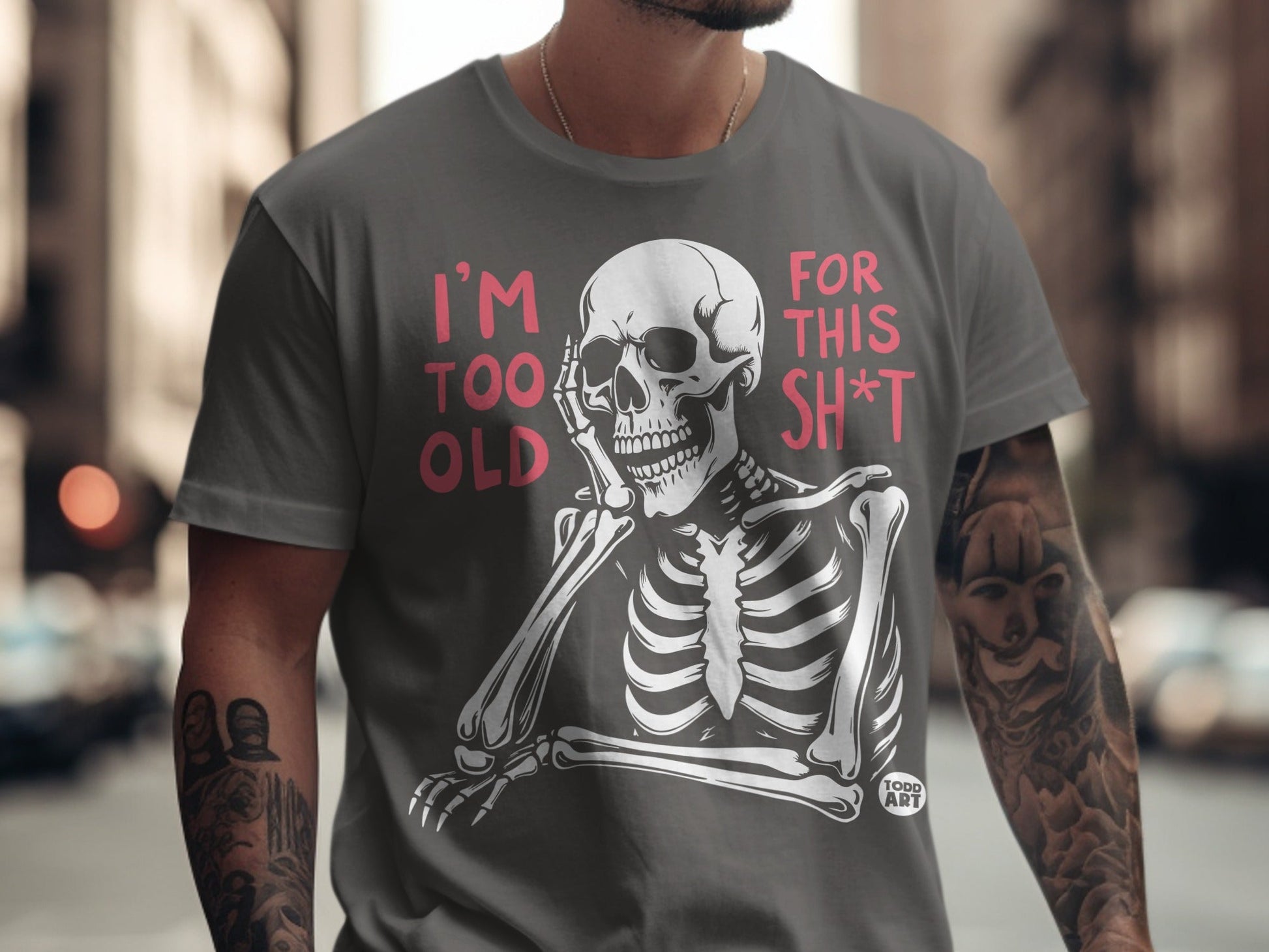 Skeleton graphic with "I'M TOO OLD FOR THIS SH*T" text on a grey t-shirt.