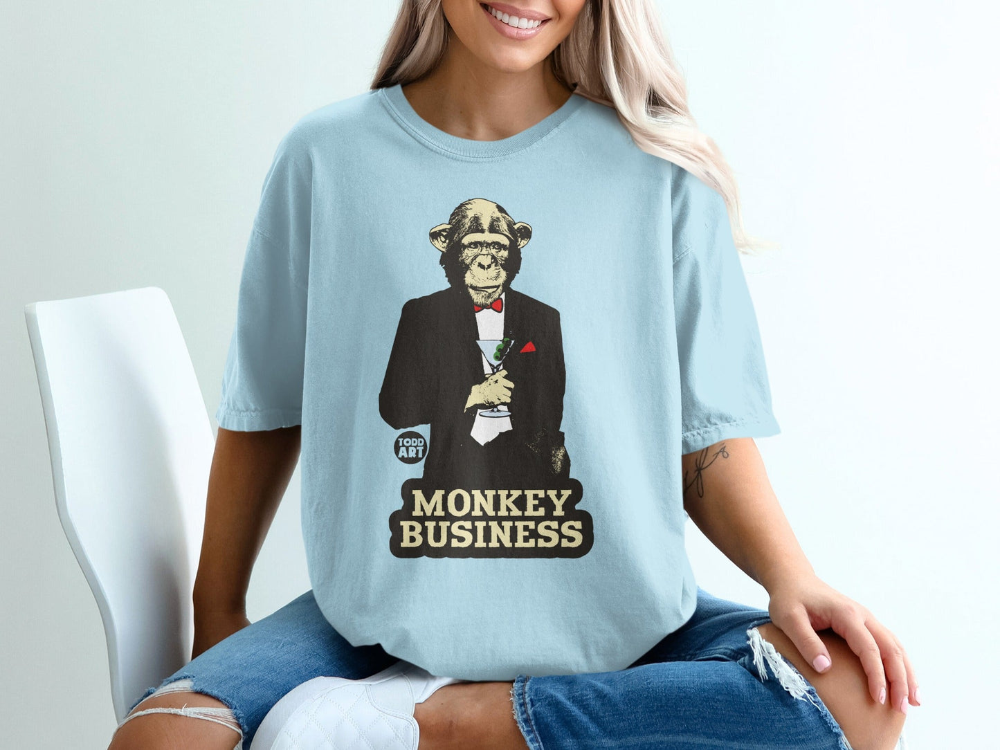 Monkey in tuxedo holding cocktail with "MONKEY BUSINESS" text.