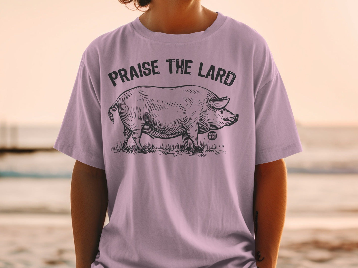 T-shirt with a pig illustration and text "PRAISE THE LARD".