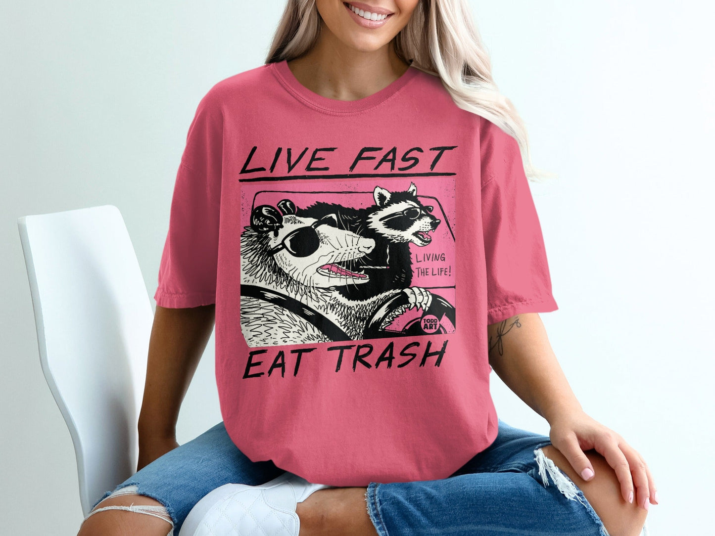 T-shirt with cartoon opossums driving, "Live Fast Eat Trash" text.