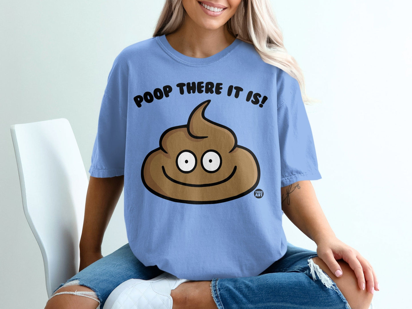 Light blue t-shirt with cartoon poop emoji and text "POOP THERE IT IS!".