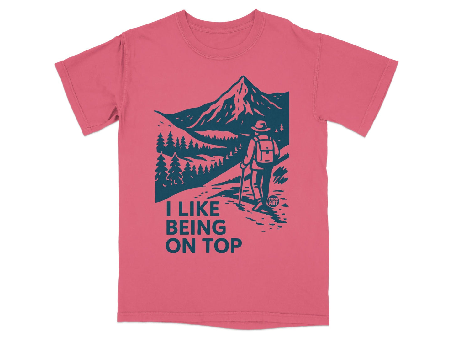 T-shirt graphic of hiker on mountain path with "I LIKE BEING ON TOP" text.